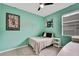 Bedroom with full-size bed, window, and art at 19820 Morden Blush Dr, Lutz, FL 33558