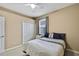 Well-lit bedroom featuring a double bed and a closet at 19820 Morden Blush Dr, Lutz, FL 33558