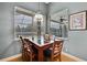 Cozy breakfast nook with a wood table and chairs, overlooking the backyard at 19820 Morden Blush Dr, Lutz, FL 33558