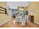 Bright dining room with hardwood floors and white table for six at 19820 Morden Blush Dr, Lutz, FL 33558