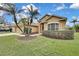 Tan house with mature palm trees and well-manicured lawn at 19820 Morden Blush Dr, Lutz, FL 33558