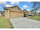 Attached two-car garage with a long driveway at 19820 Morden Blush Dr, Lutz, FL 33558