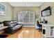 Home office features a large window, hardwood floors, and ample workspace at 19820 Morden Blush Dr, Lutz, FL 33558