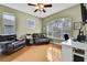 Spacious home office with leather armchairs, a large window, and built-in workspace at 19820 Morden Blush Dr, Lutz, FL 33558