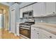 Kitchen features stainless steel appliances and white cabinets at 19820 Morden Blush Dr, Lutz, FL 33558