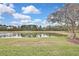 Serene lake view from the backyard, offering a peaceful natural setting at 19820 Morden Blush Dr, Lutz, FL 33558