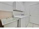 Bright laundry room with washer, dryer, sink, and cabinets at 19820 Morden Blush Dr, Lutz, FL 33558