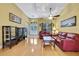 Living room with hardwood floors, leather couches, and ceiling fan at 19820 Morden Blush Dr, Lutz, FL 33558