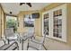 Relaxing patio with seating area and glass doors at 19820 Morden Blush Dr, Lutz, FL 33558