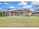 Relaxing pool area with screened enclosure and comfortable lounge chairs at 19820 Morden Blush Dr, Lutz, FL 33558
