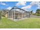 Screened-in pool with lush landscaping at 19820 Morden Blush Dr, Lutz, FL 33558