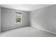 Simple bedroom with carpet, large window, and neutral walls at 2146 Laceflower Dr, Brandon, FL 33510