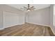 Bright bedroom featuring wood-look floors and ceiling fan at 2402 Cumberland Cliff Dr, Ruskin, FL 33570