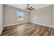 Well-lit bedroom with wood-look floors and large window at 2402 Cumberland Cliff Dr, Ruskin, FL 33570