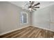 Bright bedroom with wood-look floors and arched window at 2402 Cumberland Cliff Dr, Ruskin, FL 33570
