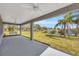 Relaxing covered patio overlooks a pond and lush landscape at 2402 Cumberland Cliff Dr, Ruskin, FL 33570
