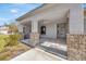 Covered front porch with brick columns and tile flooring at 2402 Cumberland Cliff Dr, Ruskin, FL 33570