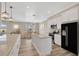 Open concept kitchen with island and black refrigerator at 2402 Cumberland Cliff Dr, Ruskin, FL 33570