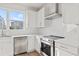 Modern white kitchen with stainless steel appliances and quartz countertops at 2506 W Cleveland St # 18, Tampa, FL 33609