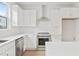 Modern white kitchen with stainless steel appliances and quartz countertops at 2506 W Cleveland St # 18, Tampa, FL 33609