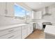 Modern kitchen with white cabinets, stainless steel appliances, and a large window at 2506 W Cleveland St # 18, Tampa, FL 33609