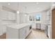 Modern white kitchen with island, stainless steel appliances, and quartz countertops at 2506 W Cleveland St # 18, Tampa, FL 33609