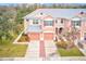 Aerial view of two-story townhouses with two-car garages and brick driveways at 26519 Castleview Way, Wesley Chapel, FL 33544