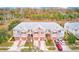 Aerial view of a row of townhouses with attached garages and lush landscaping at 26519 Castleview Way, Wesley Chapel, FL 33544