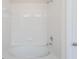 Clean bathroom with a white tiled tub and shower at 26519 Castleview Way, Wesley Chapel, FL 33544
