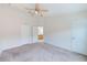 Primary bedroom with carpeted floors and ceiling fan at 26519 Castleview Way, Wesley Chapel, FL 33544