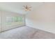 Spacious bedroom with carpeted floors and large window at 26519 Castleview Way, Wesley Chapel, FL 33544