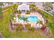 Community pool with surrounding landscaping, patio furniture, and a covered pavilion at 26519 Castleview Way, Wesley Chapel, FL 33544