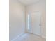 Simple entryway with tile flooring and a white door at 26519 Castleview Way, Wesley Chapel, FL 33544