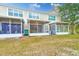 Rear view showing multiple townhouses with screened porches at 26519 Castleview Way, Wesley Chapel, FL 33544