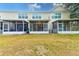 Rear view showing multiple townhouses with screened porches at 26519 Castleview Way, Wesley Chapel, FL 33544