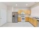 Kitchen with stainless steel appliances and light wood cabinets at 26519 Castleview Way, Wesley Chapel, FL 33544