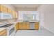 Kitchen boasts light wood cabinets and stainless steel appliances at 26519 Castleview Way, Wesley Chapel, FL 33544
