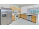 Kitchen with stainless steel appliances and light wood cabinets at 26519 Castleview Way, Wesley Chapel, FL 33544