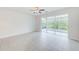 Bright living room with tile floors and access to a screened patio at 26519 Castleview Way, Wesley Chapel, FL 33544