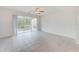Spacious living room with tile floors and sliding doors to a screened patio at 26519 Castleview Way, Wesley Chapel, FL 33544