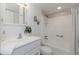 White bathroom with vanity, tub/shower, and a decorative print at 2736 Haverhill Ct # 2736, Clearwater, FL 33761