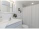 Clean bathroom with white vanity, shower/tub combo, and a palm tree print at 2736 Haverhill Ct # 2736, Clearwater, FL 33761