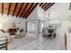 Open concept living and dining area with high ceilings and wood beams at 2736 Haverhill Ct # 2736, Clearwater, FL 33761