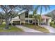 Tan two-story home with attached garage and lush landscaping at 2736 Haverhill Ct # 2736, Clearwater, FL 33761