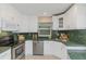 White kitchen with green countertops and stainless steel appliances at 2736 Haverhill Ct # 2736, Clearwater, FL 33761