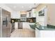 Kitchen with white cabinets, green countertops, and stainless steel appliances at 2736 Haverhill Ct # 2736, Clearwater, FL 33761