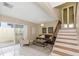 Living room with gray sofa, armchair, and staircase at 2736 Haverhill Ct # 2736, Clearwater, FL 33761