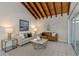 Living room with a beige sofa, coffee table, and access to a patio at 2736 Haverhill Ct # 2736, Clearwater, FL 33761
