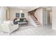 Cozy living area with a grey sofa and staircase to upper level at 2736 Haverhill Ct # 2736, Clearwater, FL 33761
