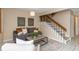 Cozy living room with gray sofa and staircase at 2736 Haverhill Ct # 2736, Clearwater, FL 33761